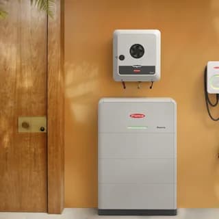 Fronius inverter, batteri og ladeboks monteret på en væg